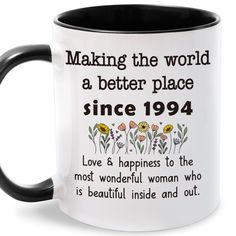 a black and white coffee mug that says making the world a better place since 1994