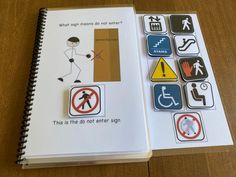 an open notebook with stickers on it and a notepad that says what signs do not enter?