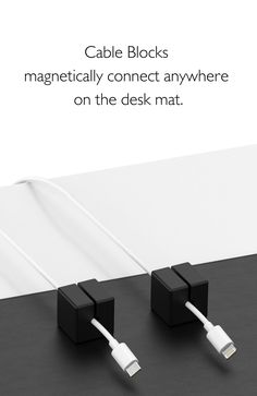 two black and white cords connected to each other on a table with text that reads cable blocks magnetic connect anywhere on the desk mat