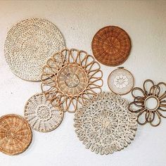 wicker baskets are arranged on the wall in order to be used as decorative pieces