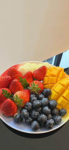 a white plate topped with fruit and cheese