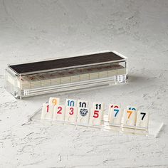 a set of numbers sitting on top of a table next to a box with magnets