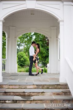 a man and woman are kissing on the steps