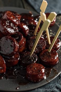 two wooden skewers sticking out of the top of some food on a plate