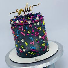 a birthday cake decorated with confetti and sprinkles on a plate