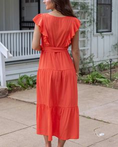 Papaya Ruffle Summer Dress | Orange Square Neck Dress Say hello to the show stopping color of the season - Papaya! This Ruffle Summer Dress features ruffle details on the sleeves and bodice, flowy tiers, and a functional waist tie - it doesn’t get more flattering than that! Put on some wedges and your favorite jewelry and you’ll be ready for all your summer celebrations. Why you’ll love it: Tiered maxi dress in eye-catching papaya color Square neckline and elastic waist with functional waist tie Midi Dress With Ruffle Sleeves For Brunch, Ruffled Flutter Sleeve Midi Dress For Vacation, Solid Color Midi Dress With Ruffles For Beach, Flutter Sleeve Dress With Ruffle Hem For Vacation, Flutter Sleeve Midi Dress With Ruffles For Vacation, Vacation Midi Dress With Flutter Sleeves And Ruffles, Vacation Dresses With Ruffle Hem And Flutter Sleeves, Spring Maxi Dress With Flutter Sleeves, Flutter Sleeve Midi Dress For Brunch