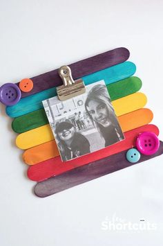 a rainbow colored photo frame with buttons attached to it