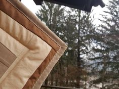 the back end of a chair with trees in the background