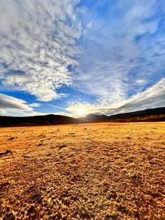 the sun is setting over an empty field with no grass or flowers on it,