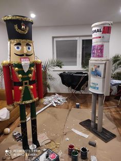 a large nutcracker statue sitting on top of a wooden floor next to a mailbox