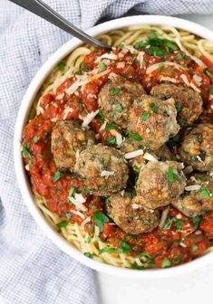 a bowl filled with spaghetti and meatballs