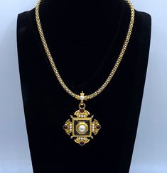 "This is a rare Monet necklace by Christian Lacroix. This Monet pendant necklace is a vintage Monet Maltese pendant and necklace that is featured in the \"Monet the Master Jewelers\" book by Alice Vega on page 283. This pendant was under license from Christian Lacroix in 1995. The pendant has pearl cabochons, dark red cabochons and black enamel on a matte gold tone. The piece is not signed Christian Lacroix, the licensed series were signed by Monet. The gold tone chain necklace is in mint condition but notice the dip in enameling on the pendant shown in the last photo. The velvet gift box is included in the purchase. Rare Monet Necklace By Christian Lacroix Monet Pendant Necklace Signed Monet, Monet Jewelry, Vintage Monet Pendant Please see the photos and don't hesitate to contact me to as The Dip, Monet Jewelry, Vintage Monet, Christian Lacroix, Jewelry Vintage, Matte Gold, Black Enamel, Maltese, Dark Red