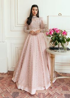 Heavy Indian Pink Lehenga for Bride in Raw Silk is Crafted with passion. This outfit is classically designed to make your memorable day as attractive as it should be. Unique craftsmanship and detailed embellishments bring heavenly hued gossamer fabrics to life, creating peaceful yet flamboyant elements of art in our bridal collection. Gown: The lehenga gown is garnished with floral bootis and finished with a heavy thick neckline with silver zardozi work. Furthermore, the choli gown is highlighte Pink Lehenga For Bride, Engagement Gowns Indian, Engagement Dress For Bride Indian, Sadaf Fawad Khan, Lehenga For Bride, Engagement Dress For Bride, Fawad Khan, Raw Silk Lehenga, Indian Pink