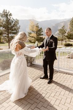 the bride and groom are dancing together on the porch at their outdoor wedding venue in colorado