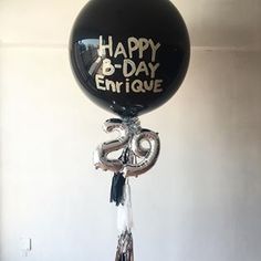 a balloon with the words happy b - day enrique written on it, hanging from a ceiling