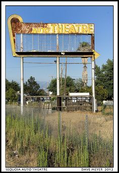 an old theatre sign in the middle of nowhere