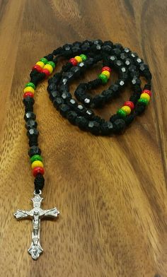 "Rasta Rosary Necklace Color: Black 20\" Inches Long Unisex Rosary FAST SHIPPING! Visit my Etsy Shop to see more Rasta Style Jewelry and Beanies! At Freedom Life Style Jewelry you will find a variety of Rasta Necklaces, Rasta Earrings and Rasta Bracelets. Click here to see more designs: https://www.etsy.com/shop/FreedomLifeStyle" Adjustable Black Rosary With Cross, Adjustable Black Cross Rosary, Handmade Black Spiritual Beads, Adjustable Black Spiritual Rosary, Handmade Spiritual Black Beads, Spiritual Black Cross Beaded Necklace, Black Beaded Cross-shaped Rosary, Black Beaded Cross Rosary, Spiritual Black Beads For Jewelry Making