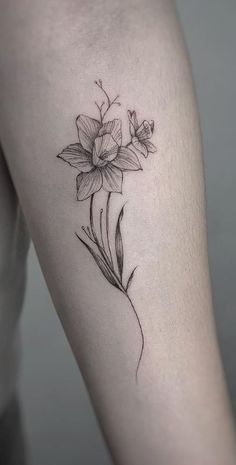 a woman's thigh with a flower tattoo on it