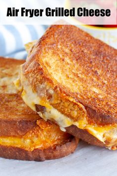 two grilled cheese sandwiches stacked on top of each other with the words air fryer grilled cheese