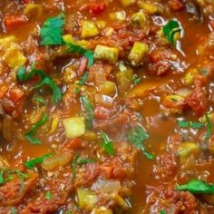 a bowl filled with meat and vegetables on top of a table