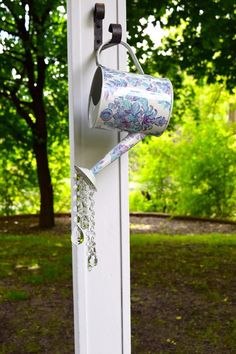 a cup hanging on the side of a white door