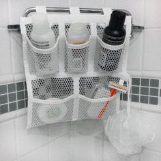 the bathroom organizer is organized with mesh baskets