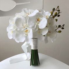 a bouquet of white flowers sitting on top of a table