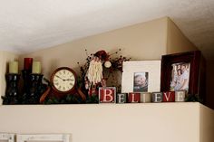 there is a shelf with pictures and other items on it, including a grandfather clock