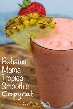 a tropical smoothie is garnished with a pineapple