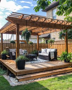 an outdoor living area with couches, tables and potted plants on the deck