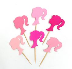 pink and pink cupcake toppers with silhouettes of women's heads on them