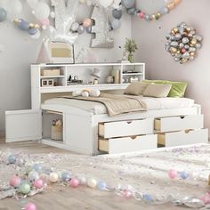 a bedroom with balloons and confetti all over the floor, including a bed