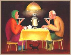 two people sitting at a table with cups and saucers in front of a lamp