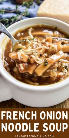 french onion noodle soup in a white bowl with a spoon