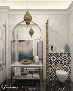 a bathroom with marble walls and flooring in gold, white and black colors is shown