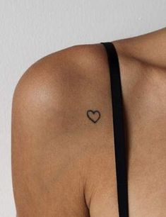 a woman with a heart tattoo on her shoulder