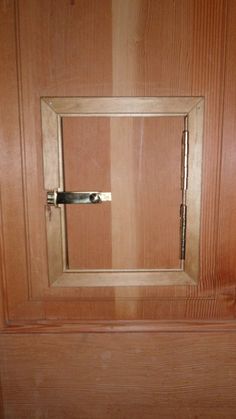 an open wooden door with a handle on it