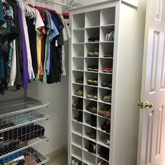 an organized closet with shoes and t - shirts hanging on the rack, next to a door