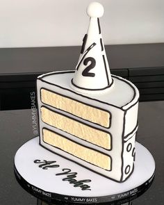 a cake that is shaped to look like a two tiered cake with the number 2 on it