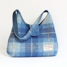 a blue plaid purse sitting on top of a white table