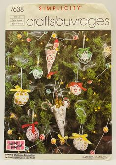 the front cover of a crocheted christmas tree with ornaments hanging from it's branches