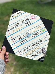 someone holding up a piece of paper with writing on it