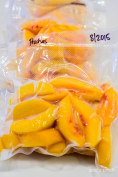 two bags filled with sliced mangos on top of a table