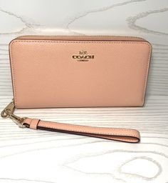 100% Authentic Coach Long Zip Around Wallet Crossgrain Leather New With Tag Color: Faded Blush  Crossgrain Leather Zip Around Closure Twelve Credit Card Slots Full-Length Bill Compartments Inside Zip Coin Pocket Detachable Wrist Strap, Gold Tone Hardware 7 1/2” (L) x 4” (H) x 1 (W) Style C3441 Comes from a Smoke Free Home   If you have any concerns, please let me know.    Buy with confidence! As customer service is my number one priority.   Payment: I accept all forms of payment that eBay lists. Classic Pink Leather Wallet, Pink Coach Leather Wallet, Pink Leather Coach Wallet, Elegant Everyday Wallets For Spring, Grizzly Man, Bow Bag, Signature Canvas, Gold Accessories, Purse Charms