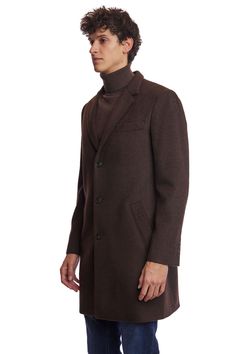 The Chocolate Brown Notch Topcoat is a timeless addition to any wardrobe. Crafted from a poly-wool blend, it features a classic notch collar, faux hair texture, and front pockets for practicality. Its rich chocolate hue and tailored fit make it appropriate for both formal and casual settings. This ensures you stay warm and stylish throughout the colder months.PRODUCT DETAILS: style 6491C slim-fitting long sleeve notch collar faux hair texture poly-wool blend dry clean only imported Classic Brown Sweater Coat For Winter, Classic Fitted Sweater Coat For Winter, Elegant Brown Outerwear With Lapel Collar, Elegant Brown Single Breasted Outerwear, Brown Fitted Wool Coat With Lapel Collar, Fitted Brown Wool Coat With Lapel Collar, Fitted Single Button Wool Coat For Business, Fitted Brown Wool Coat For Business Casual, Classic Single-breasted Winter Sweater Coat