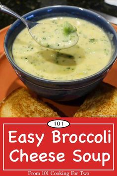 broccoli cheese soup in a blue bowl on top of toasted bread with a spoon