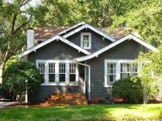 a gray house with white trim and windows