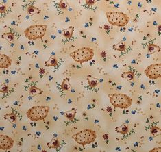 an animal themed fabric with flowers and birds on it's back side, in yellow