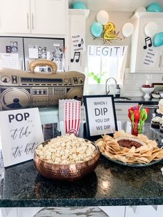 some food is sitting on top of a counter in a room with balloons and decorations