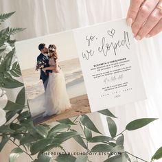 a person holding up a card with an image of a bride and groom